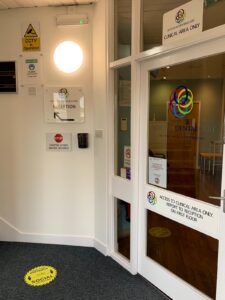 Practice entrance door with a distancing floor marker