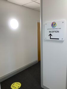 Corridor with a sign directing patients to reception