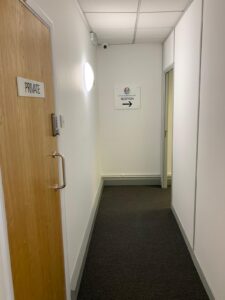 Corridor with a sign directing patients to reception