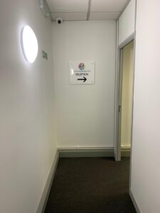 Corridor with a sign directing patients to reception