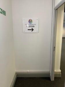 Corridor with a sign directing patients to reception