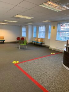 Waiting area seating behind a red distancing line
