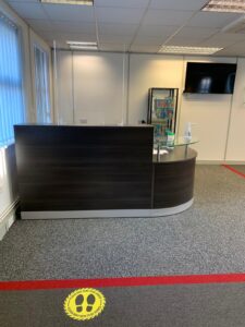 Reception desk with a two-metre floor marker