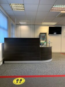 Reception desk with a two-metre floor marker