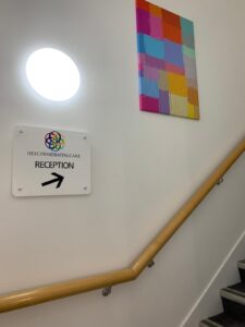 Staircase with a sign directing patients to reception