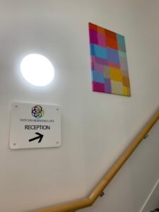 Staircase with a sign directing patients to reception