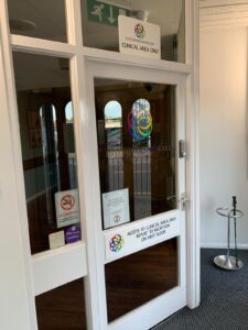 Clinical area door with social distancing notices
