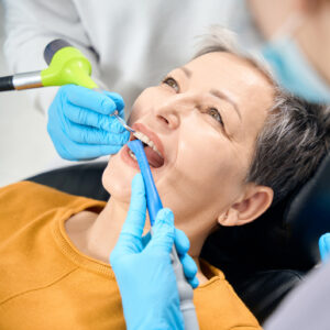 Hygienist cleaning a patient’s teeth