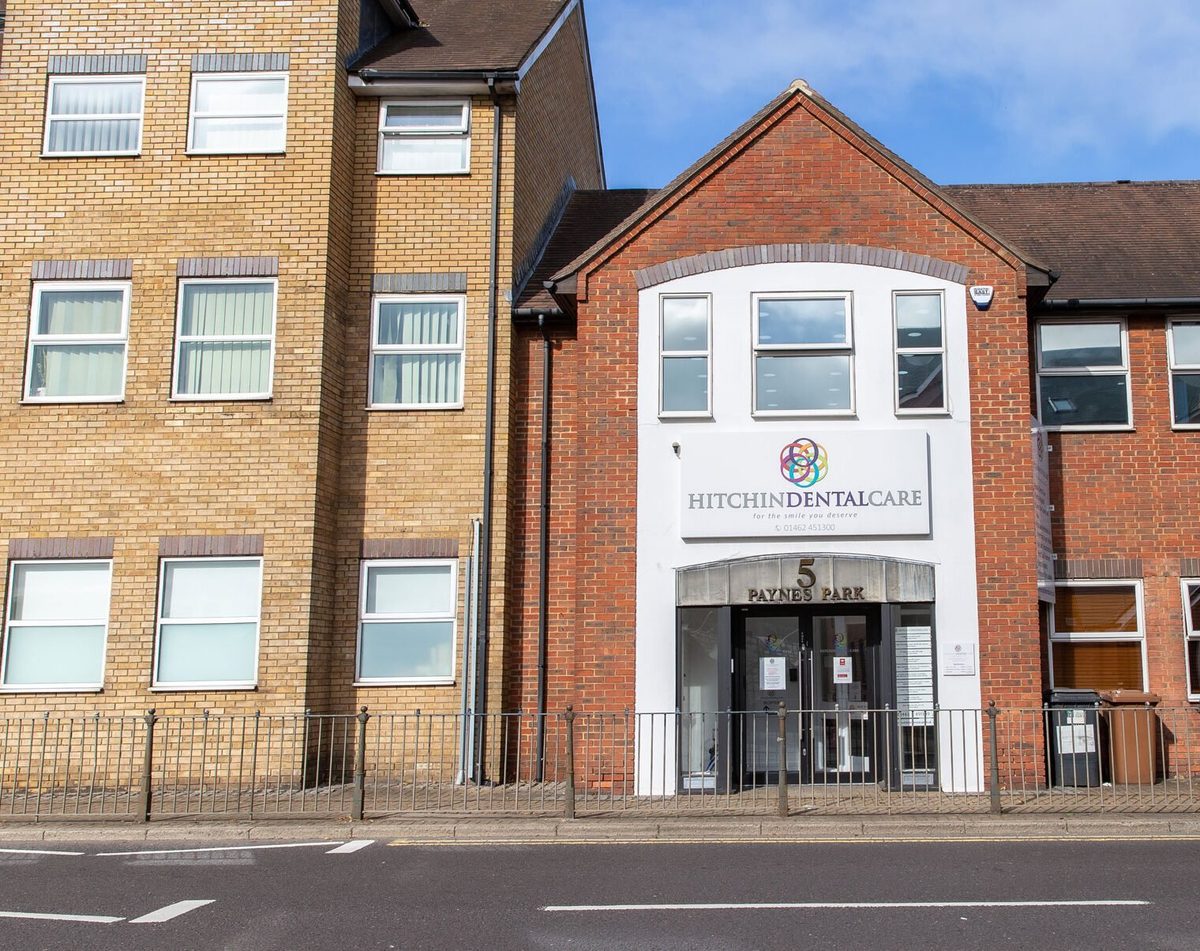 The front of Hitchin Dental Care at 5 Paynes Park, a red-brick building with the practice sign above the entrance